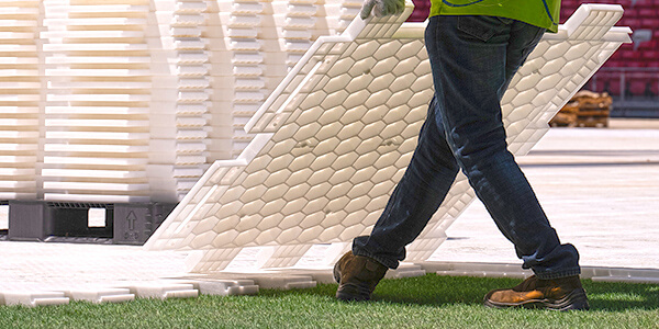 Man installs EverBase over turf in a stadium