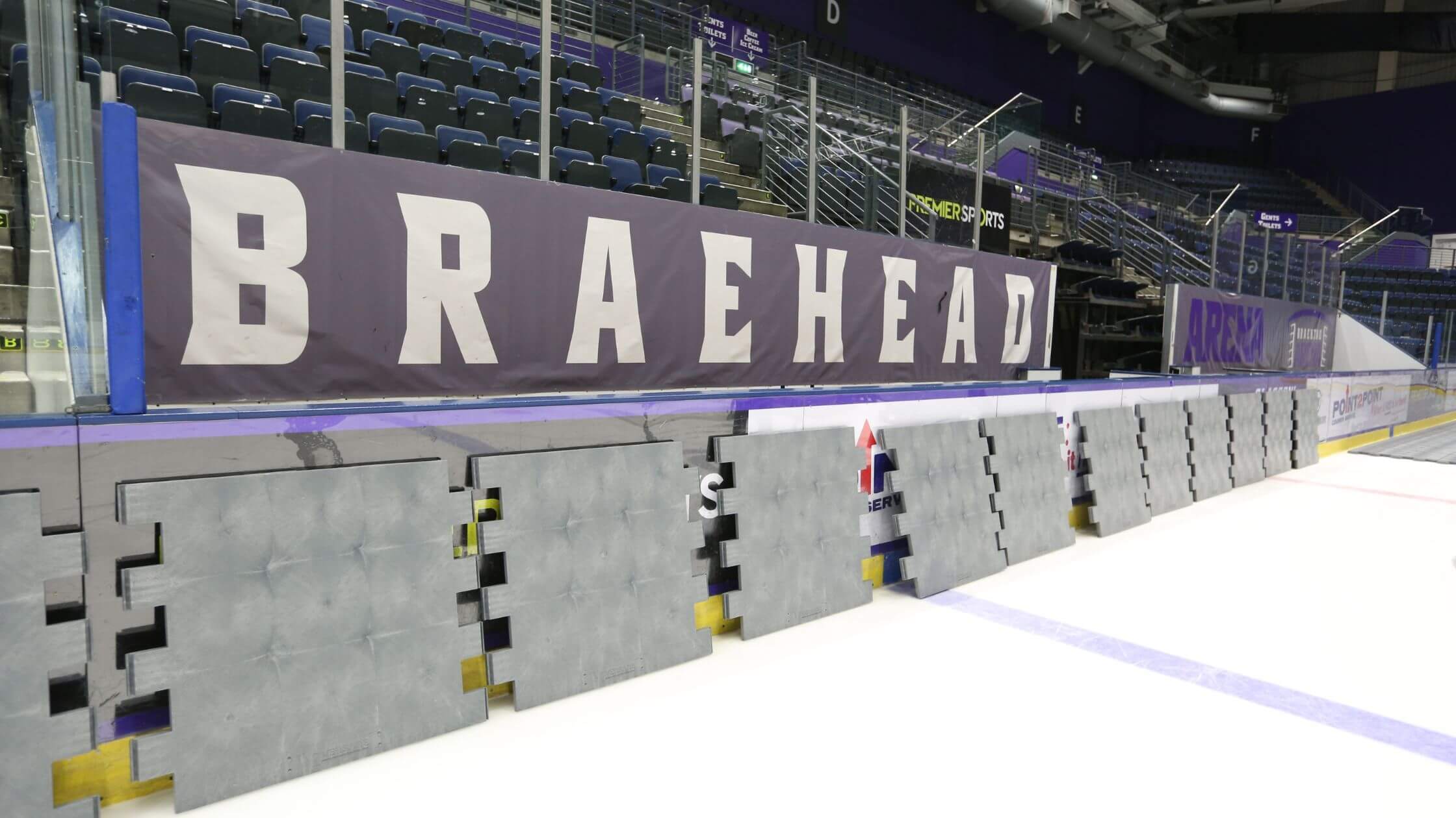EverBase Tiles stacked against the side of an ice rink